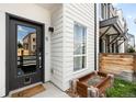 Charming front door with modern design, complemented by neat landscaping and exterior details at 3520 W Connejos Pl # 5, Denver, CO 80204