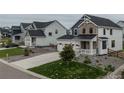 View of the home showcasing its architectural style, manicured lawn, and neighborhood setting at 1143 Williams Loop, Elizabeth, CO 80107