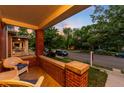 Inviting front porch features classic brick details and comfortable wicker seating with a street view at 534 S Pearl St, Denver, CO 80209