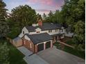 An aerial view captures this two-story home with mature trees and a well-maintained lawn and attached garage at 2684 Taft Ct, Lakewood, CO 80215