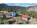 Aerial view of a charming property nestled in the mountains, showcasing the home and its unique setting with mountain views at 319 Camino Bosque, Boulder, CO 80302