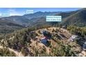 Aerial view of a serene property set among lush trees, highlighting the home's location near hiking and biking trails at 319 Camino Bosque, Boulder, CO 80302