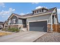 Home exterior with a two-car garage and inviting curb appeal at 11346 Kittredge St, Commerce City, CO 80022