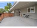 Covered front patio featuring a small table, chairs and decor, with a nice wood accent feature at 7911 Raleigh Pl, Westminster, CO 80030