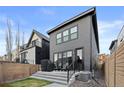 The backyard has a modern deck with railing, great space for outdoor living and entertaining at 3646 Quivas St, Denver, CO 80211