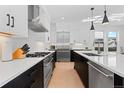 Modern kitchen boasts sleek white cabinets, stainless steel appliances, and a spacious center island at 3646 Quivas St, Denver, CO 80211