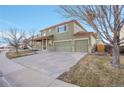 Attractive two-story home with a large driveway, mature trees, and well-maintained landscaping at 6348 Westview Cir, Parker, CO 80134