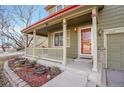 Inviting front porch featuring a cozy seating area and meticulously maintained landscaping at 6348 Westview Cir, Parker, CO 80134