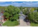 Aerial shot of a gray home with lush landscaping and mature trees at 11760 Eudora Ct, Thornton, CO 80233