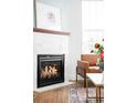 Close-up of a modern fireplace with a tiled surround and a decorative mantel, adding warmth and elegance to the room at 2028 Ulster St, Denver, CO 80238