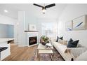 Cozy living room featuring a fireplace, modern decor, and comfortable seating at 2028 Ulster St, Denver, CO 80238