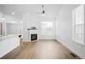 Bright living room featuring a corner fireplace and vinyl plank flooring at 2028 Ulster St, Denver, CO 80238