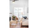 Living room with large window, a white couch, and a marble fireplace at 2028 Ulster St, Denver, CO 80238