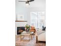 Living room with a marble fireplace, an area rug, and a brown leather chair at 2028 Ulster St, Denver, CO 80238