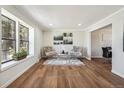 Bright living room featuring hardwood floors, large window, and modern decor at 12807 Garfield Cir, Thornton, CO 80241