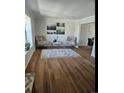 Cozy living room features wood floors, neutral walls, and comfortable seating at 12807 Garfield Cir, Thornton, CO 80241