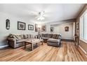 Bright living room with hardwood floors, sectional sofa, and large windows at 3792 E Briarwood Ave, Centennial, CO 80122