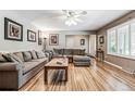 Bright living room with hardwood floors, sectional sofa, and large windows at 3792 E Briarwood Ave, Centennial, CO 80122