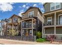Charming street view of modern homes with covered balconies and well-maintained landscaping at 8953 Southurst St, Littleton, CO 80129