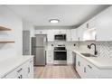 Bright kitchen with modern cabinets, stainless steel appliances, and stylish herringbone backsplash at 3470 S Poplar St # 401, Denver, CO 80224