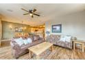 Inviting living room featuring a leather sofa, rustic coffee table, and a view into the adjacent kitchen area at 62 Broken Lance Dr # 202E, Breckenridge, CO 80424