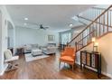 Inviting living room featuring hardwood floors, comfortable seating, natural light, and staircase at 6365 Orion Ct # B, Arvada, CO 80403