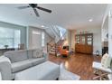 Open living room with hardwood floors, cozy seating, and a staircase leading to the upper level at 6365 Orion Ct # B, Arvada, CO 80403