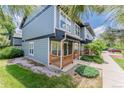 Two-story townhouse with a covered front porch, blue siding, and manicured landscaping at 1459 S Pierce St, Lakewood, CO 80232