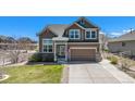 Charming two-story home with an attached two-car garage and a neatly kept front lawn at 5404 Fawn Ridge Way, Castle Rock, CO 80104