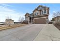 Lovely two-story home featuring an ample driveway and a well-maintained lawn in quiet area at 5404 Fawn Ridge Way, Castle Rock, CO 80104