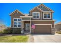 Inviting two-story home featuring a well-manicured lawn and an attached two-car garage at 5404 Fawn Ridge Way, Castle Rock, CO 80104