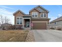 Beautiful two-story home with inviting curb appeal, manicured lawn and an attached garage at 5404 Fawn Ridge Way, Castle Rock, CO 80104