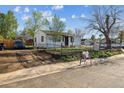 View of this property featuring a fenced yard and convenient off-street parking, combining style and functionality at 4401 W Mississippi Ave, Denver, CO 80219