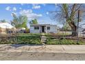 A quaint, fenced front yard enhances this property, offering a secure and charming outdoor space at 4401 W Mississippi Ave, Denver, CO 80219