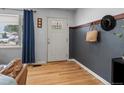 Stylish entryway featuring hardwood floors, accent wall, decorative wall hangings, and natural light from a nearby window at 1670 Oakland St, Aurora, CO 80010
