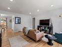 Bright living room featuring hardwood floors, recessed lighting, and modern furniture, creating a cozy and inviting space at 1670 Oakland St, Aurora, CO 80010