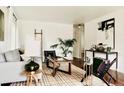 Cozy living room featuring stylish décor, hardwood flooring, bright white walls and an open layout at 4422 W 27Th Ave, Denver, CO 80212