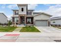 Charming two-story home with a stone facade, covered porch and manicured lawn at 5964 E 141St Ave, Thornton, CO 80602