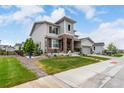 Beautiful home with landscaped yard, stone accents, and a convenient two-car garage at 5964 E 141St Ave, Thornton, CO 80602