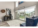 Bright living room features a large sliding glass door and neutral decor at 5964 E 141St Ave, Thornton, CO 80602