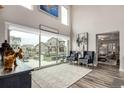 Bright living room with high ceilings, large windows and an open floor plan at 5964 E 141St Ave, Thornton, CO 80602