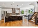 Open kitchen with modern cabinets, large island with seating, and stainless steel appliances at 1911 S Lafayette St, Denver, CO 80210