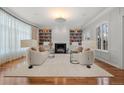 Elegant living room with a fireplace, custom built-ins, hardwood floors, and large windows for natural light at 425 Monroe St, Denver, CO 80206