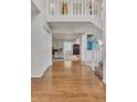 Bright foyer boasts hardwood floors, staircase, and an open view to the living space, creating a welcoming atmosphere at 7183 S Poplar St, Centennial, CO 80112