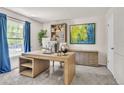 Stylish home office features a modern desk, ample storage, and a large window providing natural light at 7183 S Poplar St, Centennial, CO 80112