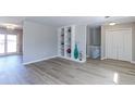 Spacious living room showcasing a built-in shelving unit and light hard wood flooring at 383 S 21St Ave, Brighton, CO 80601
