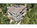 An aerial view showcasing the home's multi-level decks, balconies, and lush, surrounding trees at 1250 Dolan Dr, Monument, CO 80132