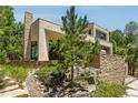 A contemporary home featuring stacked stone accents and a modern design with a manicured garden at 1250 Dolan Dr, Monument, CO 80132