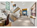 Bright and airy foyer with high ceilings, staircase, and modern design elements at 1250 Dolan Dr, Monument, CO 80132