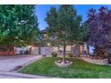 Beautiful two-story home with stone accents, mature trees, and a well-manicured lawn at 12350 Turquoise Terrace St, Castle Pines, CO 80108